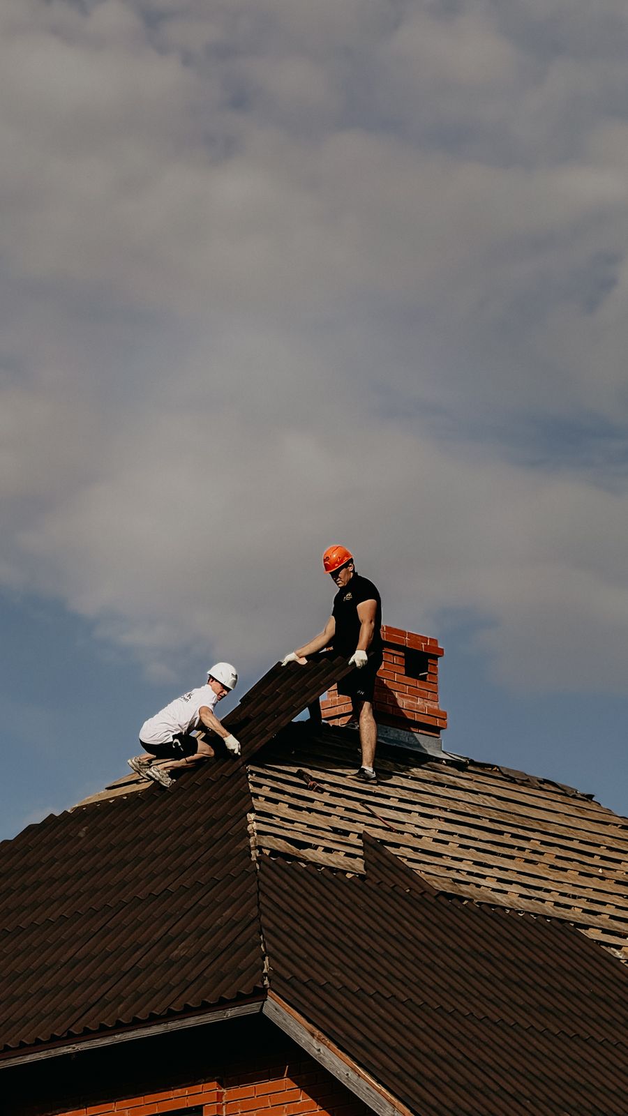 Roofer installing new shingles, related to blog article on storm prep
