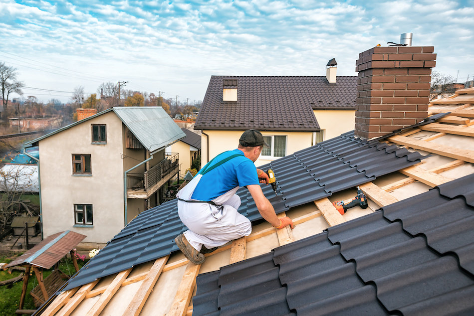 Belfast Roofing Experts roofer installing new shingles on a residential roof